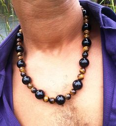 💥 Incredible Energy: You can feel this necklace when you put it on. A gentle but noticeable vibration is emitted from this combination of crystals proving they are more than just jewelry. A sense of knowing that you are a safe and all is well.💪 Large Powerful Crystals and Healing Stones: We use 12mm Onyx for its extremely protective nature. 📏 Size The interior circumference of this necklace is 21 inches (With the option for additional length)🐯 Tiger Eye (a.k.a golden tiger eye) is a fantasti Black Tourmaline Jewelry, Powerful Crystals, Tiger Eye Necklace, Black Tourmaline Necklace, Mens Beaded Necklaces, Tiger Eye Jewelry, Tigers Eye Necklace, Black Onyx Necklace, Onyx Necklace