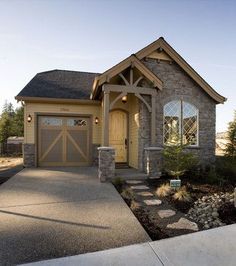 a house that has a driveway in front of it and a garage on the other side