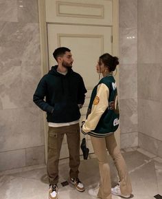 a man and woman standing in front of a door