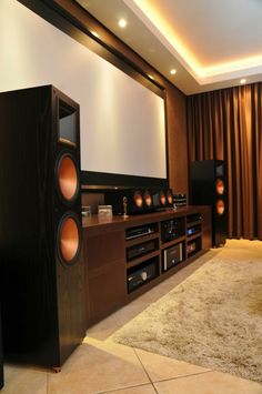 a living room with speakers and a large screen