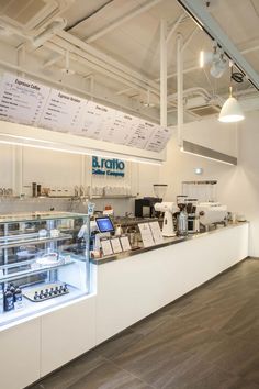 the interior of a deli with many items on display in glass cases and lights