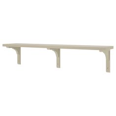 a white shelf sitting on top of a wall