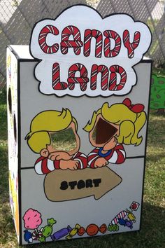 a cardboard candy land sign on the grass