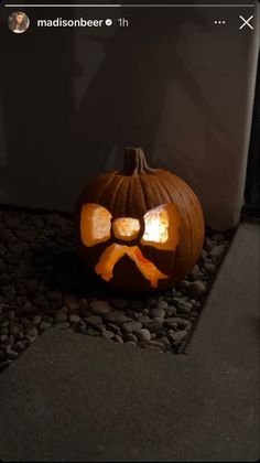 a carved pumpkin with a dog bone on it