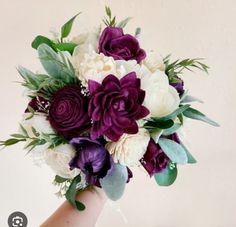 a bridal bouquet with purple and white flowers