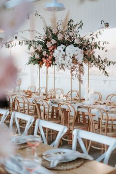 the tables are set with white and pink flowers