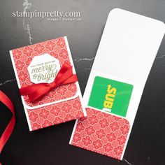 a close up of a card with a red ribbon on it and a tag that says merry bright