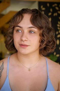 Short curly haircut with curtain bangs and voluminous texture Curly Haircut With Curtain Bangs, Face Framing Layers, Voluminous Curls