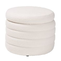 four white round cushions stacked on top of each other in front of a white background