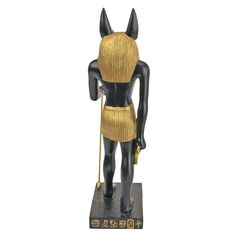 an egyptian figurine is shown in gold and black colors, with the headdress on it's chest