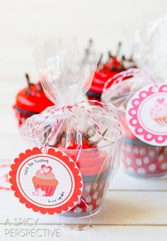 cupcakes wrapped in cellophane and sitting on a table next to each other