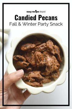 a person holding a bowl filled with food and text that reads candied pecans fall & winter party snack