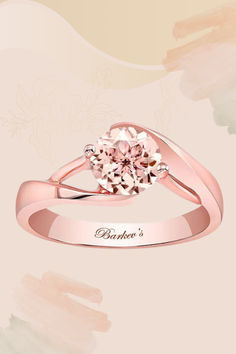 a pink diamond ring with the name, barbara's written in gold on it