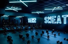 the gym is lit up with neon lights