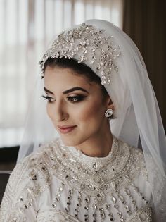 a woman wearing a white veil and tiara