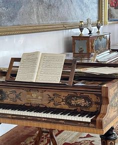 an old piano with music sheets on it