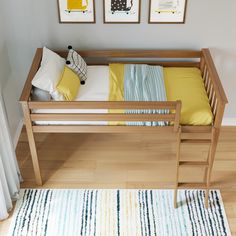 a wooden bed frame with yellow and blue pillows on top of it next to a white rug