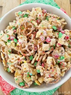 a white bowl filled with lucky charms cereal mix on top of a green and red napkin