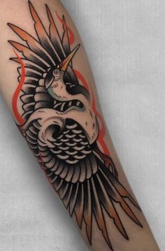 an arm with a bird on it and flames in the air behind it, as well as a tattoo design