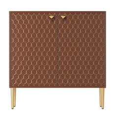 a brown cabinet with gold legs and an intricate design on the front, against a white background