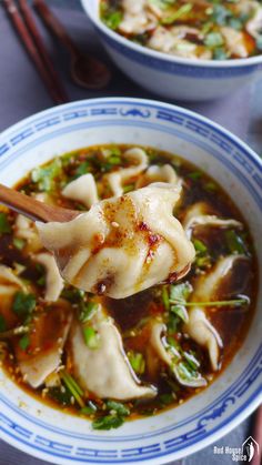 two bowls of soup with dumplings and chopsticks