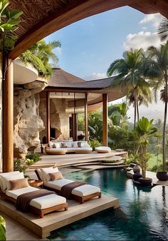 an outdoor swimming pool with chaise lounges and palm trees in the back ground