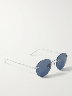 Cartier Eyewear's frameless sunglasses are both sleek and lightweight. They have a slim, silver-tone nose bar and arms, plus cool blue lenses. Frameless Sunglasses, Cartier Sunglasses, Silver Sunglasses, Aviator Style, Optical Glasses, Blue Lenses, Oval Frame, Sunglasses For Men, Gold Sunglasses