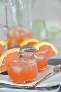 grapefruit and orange margaritas on a plate with silverware