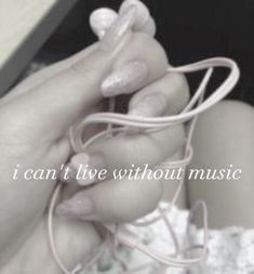 a woman's hands holding a string with the words i can't live without music