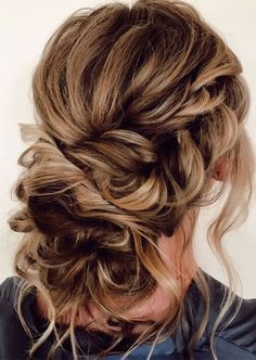 a woman with blonde hair styled into a messy updo