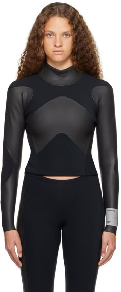 a woman in black wetsuit with long sleeves