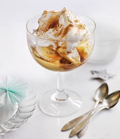 an ice cream sundae in a glass with spoons