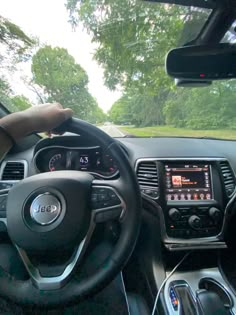 the interior of a car with dashboard, steering wheel and dash board showing various electronic devices