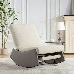 a living room with a white chair and a plant in the corner next to it