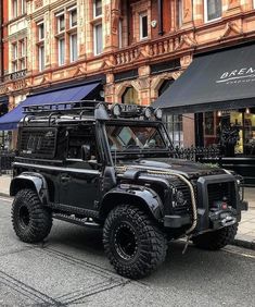 a black jeep parked in front of a building