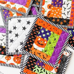 a quilted halloween themed table runner with pumpkins and jack - o'- lanterns