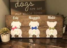 a wooden sign with three dogs on it