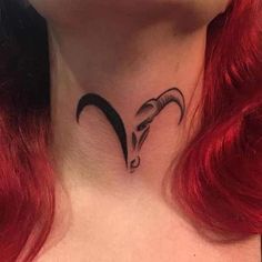 a woman's neck with a goat tattoo on it