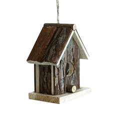 a birdhouse hanging from a rope on a white background