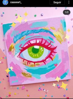 an eye painted on a canvas surrounded by confetti