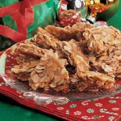 a pile of granola on a plate with christmas decorations in the back ground behind it