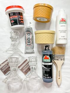 the contents of a shaving kit are arranged on a white surface, including an orange brush and some other items