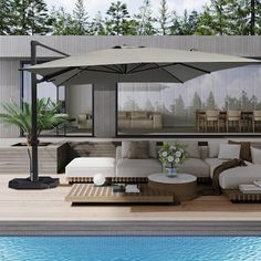 an outdoor living area next to a swimming pool with furniture and umbrellas on it