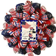 a red, white and blue patriotic wreath with mickey mouse on the front is shown