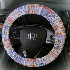 a car steering wheel cover with flowers on it