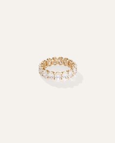 a gold ring with white stones