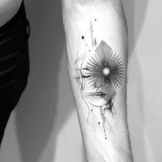 a woman's arm with a tattoo on it and a sunflower in the middle