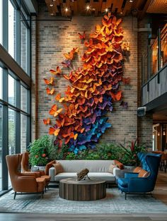 a living room filled with lots of furniture next to large window covered in colorful paper butterflies