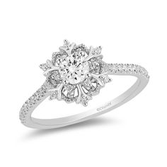 a white gold engagement ring with diamonds on the shoulders and an oval center stone in the middle