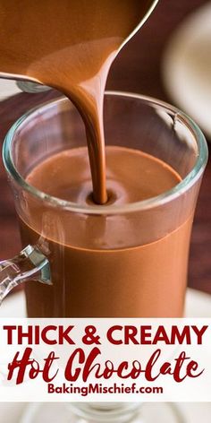 chocolate being poured into a glass mug with the words thick & creamy hot chocolate